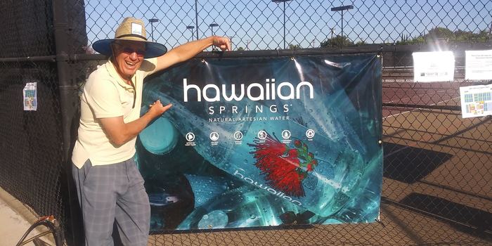 Coach Jim with Hawaiian Springs sponsor banner